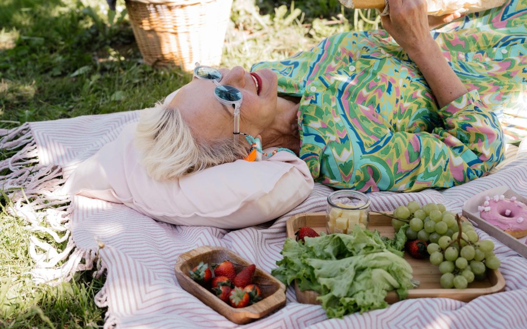 old woman lying on a picnic blanket